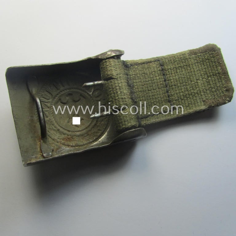 WH (Heeres) 'tropical-issued' belt-buckle being a non-maker-marked, field-grey-coloured example that comes mounted onto its original, greenish-coloured- (and/or: 'webbing'-based-) tab