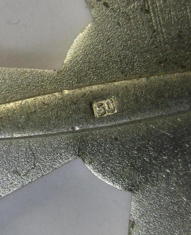 Luxuriously-styled, 'Kriegsverdienstkreuz 1. Klasse ohne Schwertern' being an attractive and maker- (ie. '50'-) marked specimen that is executed in typical, silverish-coloured metal (ie. 'Buntmetall') and that comes in a wonderful condition