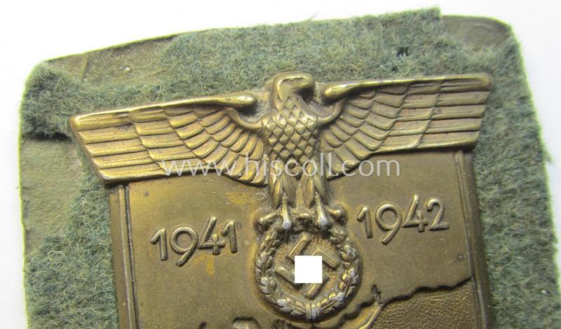 Attractive, WH (Heeres o. Waffen-SS) 'Krim'-campaign-shield that comes mounted onto its original, field-grey-coloured 'backing' and that comes in an issued-, minimally worn and/or (I deem) carefully tunic-removed-, condition