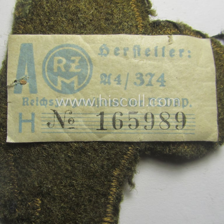 N.S.K.K. (ie. 'National Socialistisches Kraftfahr Korps') arm-eagle as executed in so-called: 'flat-wire', 'BeVo'-weave pattern and comes mounted onto a earthen-green-coloured (and/or woolen-based) 'backing' (and that still retains its 'RzM'-etiket)