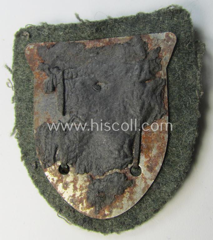 Attractive, WH (Heeres o. Waffen-SS) 'Krim'-campaign-shield that comes mounted onto its original, field-grey-coloured 'backing' and that comes in a surely issued-, minimally worn and/or (I deem) carefully tunic-removed-, condition