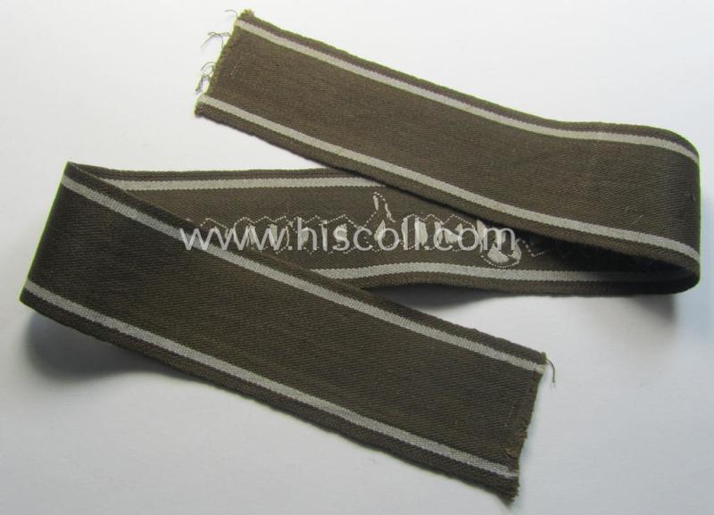 Superb - and scarcely encountered! - example of a WH (Heeres) cuff-title ie. armband (ie. 'Ärmelstreifen') entitled: 'Feldgendarmerie' (being a typical 'semi-BeVo'-woven!) example that comes in a full length- ie. non-shortened, condition