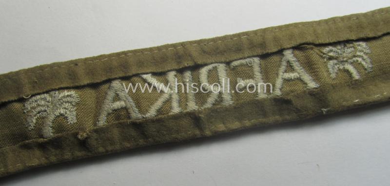 WH cuff-title (ie. 'Ärmelstreifen') entitled: 'Afrika' (being an example that bears a printed 'RbN.'-numeral ('RBN.0/0250/2340') and that comes in an issued, clearly worn- and/or most certainly once tunic-attached, condition)