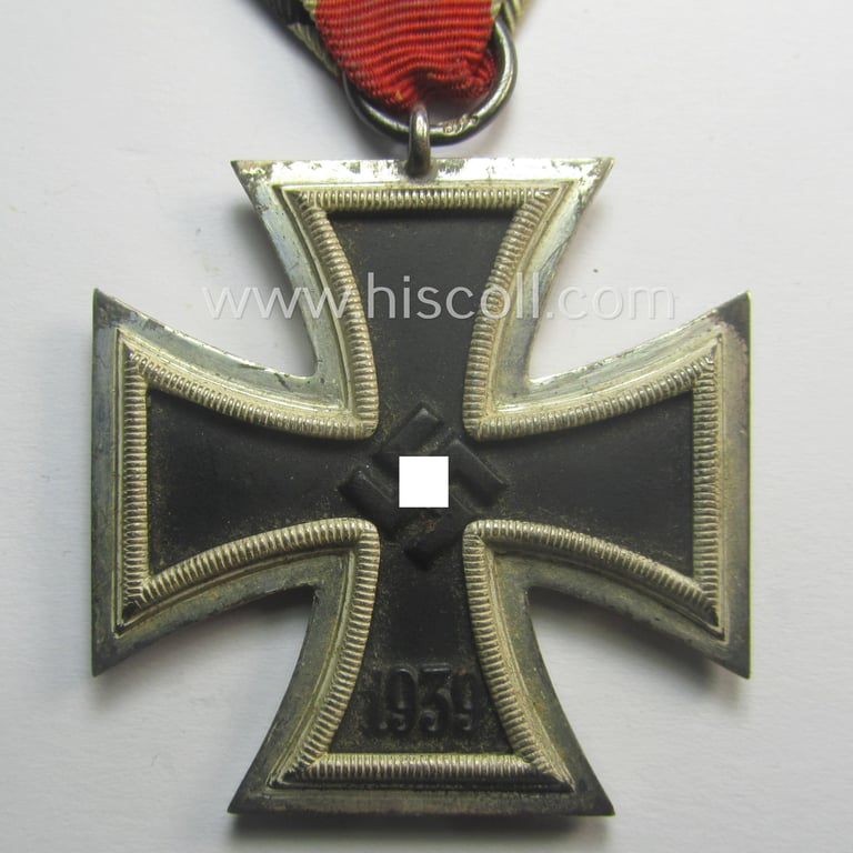 'Eisernes Kreuz II. Klasse' being a neatly maker- (ie. 'L/18'-) marked example that comes mounted onto its period- and confectioned ribbon (ie. 'Bandabschnitt') as was produced by the maker (ie. 'Hersteller'): 'B.H. Mayer's Kunstprägeanstalt'