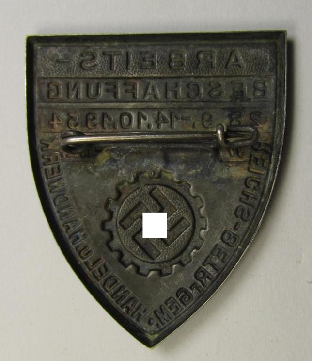 Silver-toned- (and/or tin-based) RAD- (ie. 'Reichsarbeitsdienst'-) related day-badge depicting a so-called: 'RAD-Zahnrad' and text: 'Arbeitsbeschaffung - 28.9.-14.10.1934 - Wttbg. Hohenz.' and sub-titled: 'Reichs-Betr. Gem. - Handel u. Handwer...