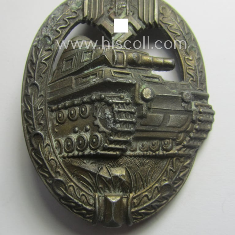 'Panzerkampfabzeichen in Bronze' (or: bronze-class panzer-assault badge or PAB) being a clearly maker- (ie. 'AS' in a triangle-) marked- and/or typical zinc- (ie. 'Feinzink'-) based specimen as was procuced by a to date unknown maker