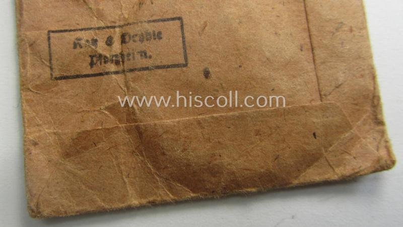 'Luftschutz-Ehrenzeichen 2. Stufe' being a maker- (ie. '10'-) marked example, as executed in zinc-based metal (ie. 'Feinzink') and that comes stored in its (scarcely seen!) 'Zellstoff'-based pouch by the maker: 'Katz u. Deyhle'