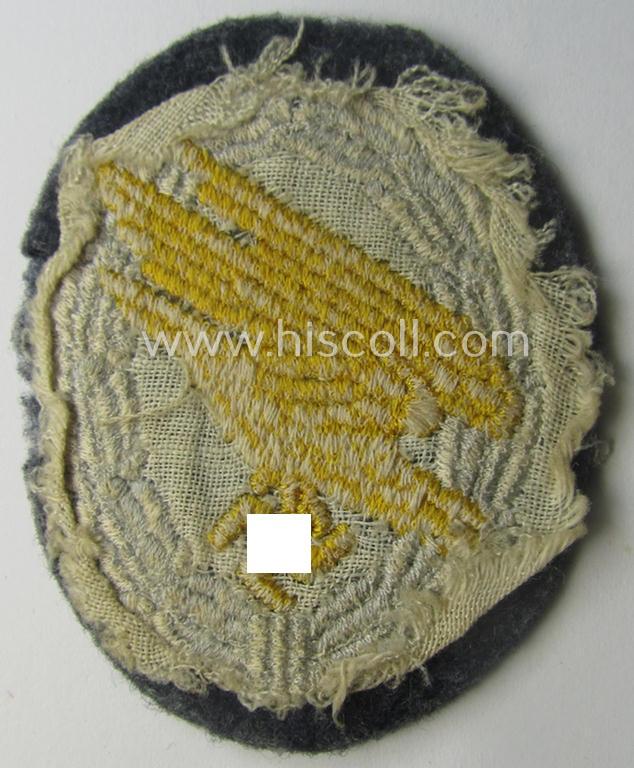 Truly used- and/or carefully tunic-removed, WH (Luftwaffe) 'Fallschirmschützen-Abzeichen in Stoff' (or: cloth-based paratroopers'-jump-badge) being a nicely machine-embroidered specimen that comes in a just moderately used- ie. worn, condition
