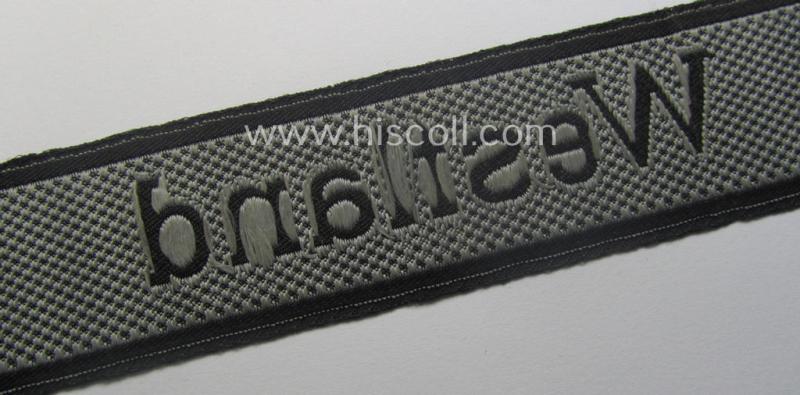 Waffen-SS, 1943/44 pattern cuff-title (ie. 'Ärmelstreifen') depicting the machine-woven Latin script text in silver-grey linnen as was intended for a member of the: 'SS-Regiment': "Westland" (ie. part of the: '5. SS-Pz-Gren.-Div. "Wiking")