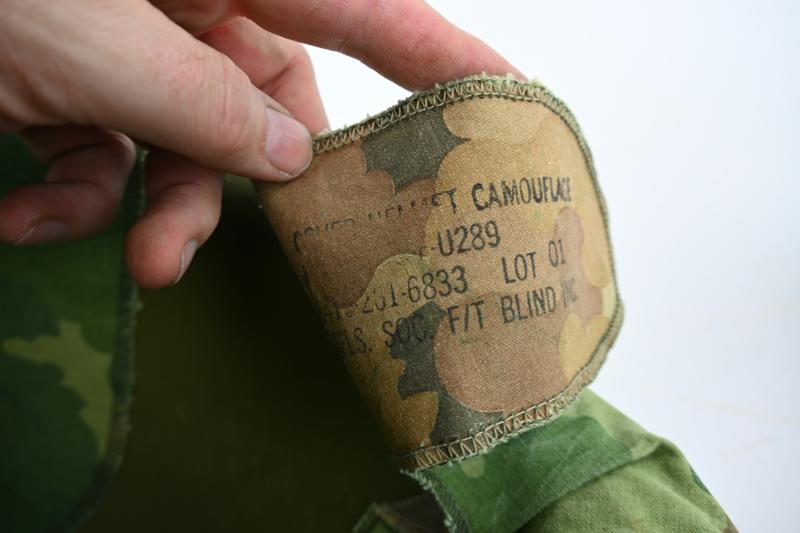 US Vietnam War Infantry helmet with camouflage cover and attached content