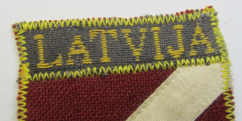 Superb - and truly rarely seen! - locally produced(!), 'Waffen-SS'-type armshield as (partly) executed in the so-called: 'semi-BeVo'-pattern entitled: 'Latvia' as was merely intended for usage by the members of the: 'Latvian Legion'