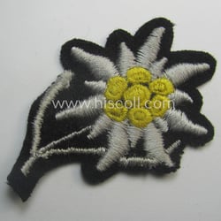 Waffen-SS-pattern, black-coloured M43-cap-insignia (ie. 'Mützenabzeichen') depicting an: 'Edelweiss'-flower...