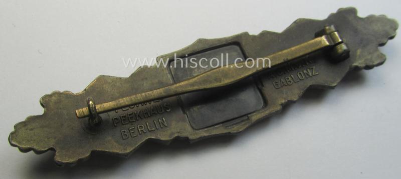 'Nahkampfspange in Bronze' (or: bronze-class close-combat clasp ie. CCC) being a maker- (ie. 'A.G.M.u.K.'-) marked- and/or minimal converse-shaped specimen having its period-attached (black-toned and steel-based) 'back-plate' in place