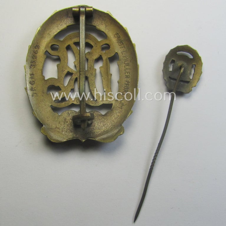 'Reichssportabzeichen DRL in Bronze' (or: bronze class DRL sports'-badge) being a maker- (ie. 'Ernst L. Müller'-) marked and that comes with its accompanying miniature