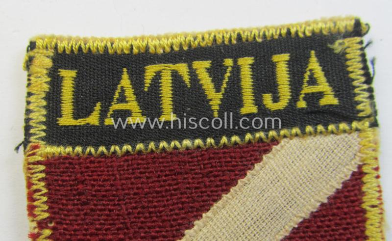 Superb - and truly rarely seen! - multi-piece-constructed, linnen-based and locally produced(!), 'Waffen-SS'-type armshield entitled: 'Latvia' as was merely intended for usage by the members of the: 'Latvian Legion'