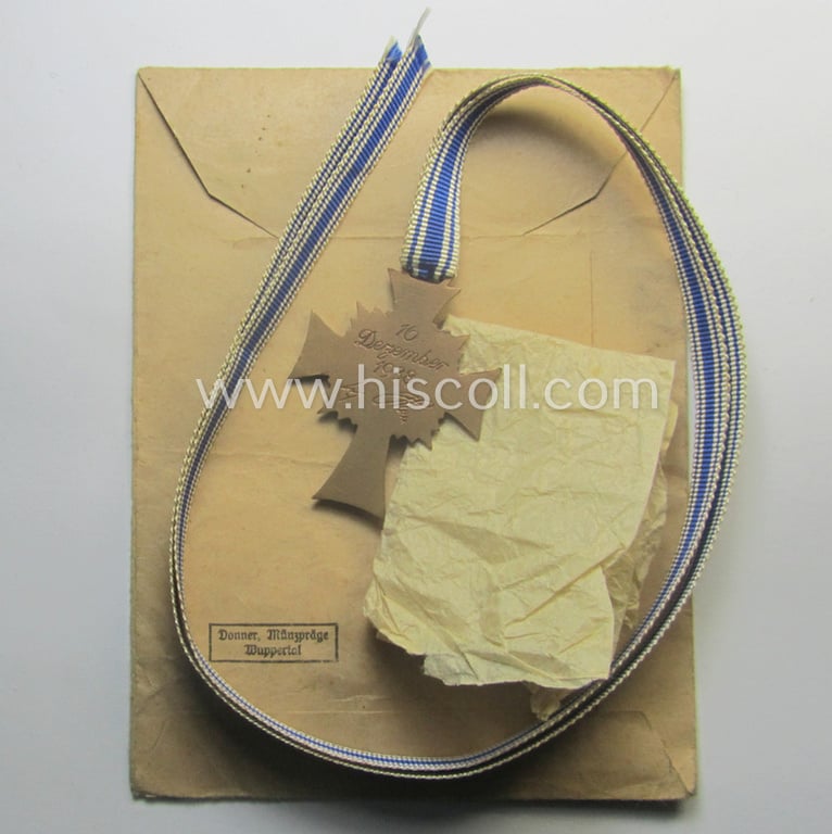 'Ehrenkreuz der deutschen Mutter - dritte Stufe' (or: bronze-class mothers'-cross) that came mounted onto its long-sized ribbon and that came stored in its period pouch by the maker: 'Donner Münzpräge - Wuppertal'