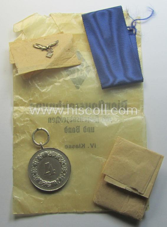 Superb - and usually seen! - WH (Luftwaffe) bright-silver-toned, 'WH-DA der 4. Klasse für 4 Jahre Dienstzeit' that comes with its accompanying ribbon (ie. 'Bandabschnitt') and eagle-device as stored in its period 'Cellophan'-based pouch