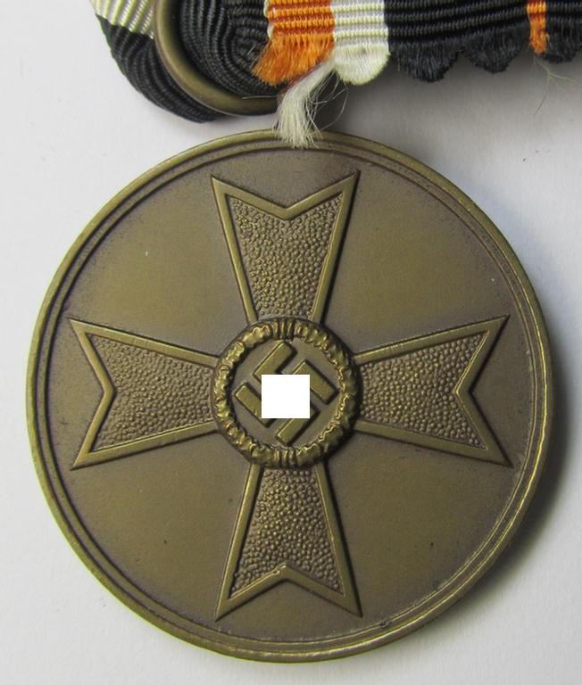 Attractive 'Kriegsverdienstmedaille 1939' being a non-maker-marked- (and/or: 'Buntmetall'-based) specimen that came mounted onto its (orange-coloured- and truly long-sized!) ribbon (ie. 'Bandabschnitt')