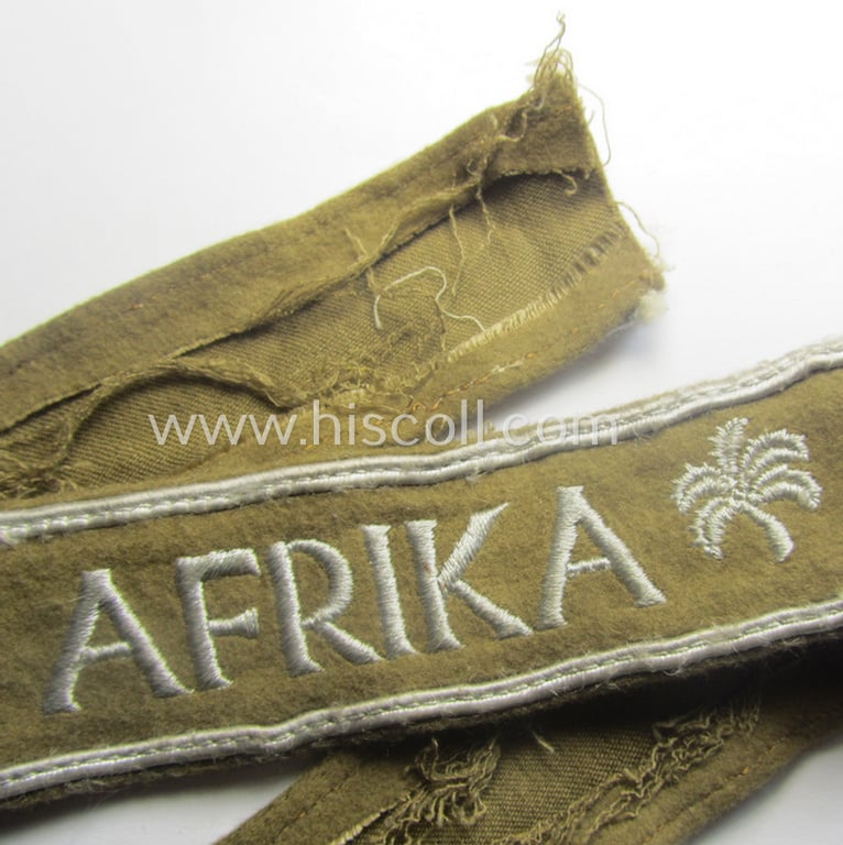 WH (LW o. Heeres) cuff-title (ie. 'Ärmelstreifen') entitled: 'Afrika' (being an example that comes in a presumably issued- albeit simply never used- ie. 'virtually mint' condition)