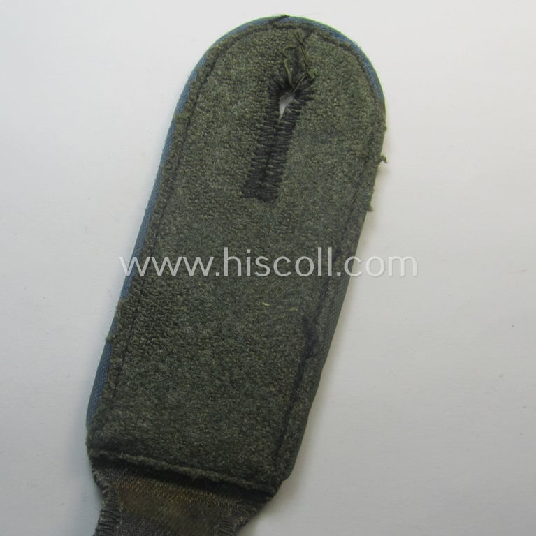 Attractive - albeit regrettably single! - Waffen-SS, EM-type shoulderstrap as piped in the bright-blue-coloured branchcolour as was intended for usage by an: 'SS-Mann' who served within the: 'SS-Nachschub-Trpn.'