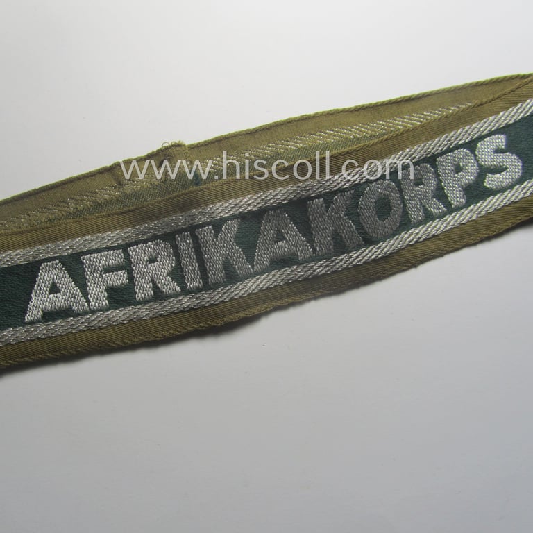 Minimally worn, 'BeVo'-like cuff-title (ie. 'Ärmelstreifen') entitled: 'Afrikakorps' being a with certainty issued example that comes in an overall very nice- (ie. non-shortened- and/or once tunic-attached-), condition