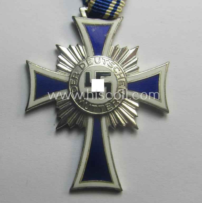 'Ehrenkreuz der deutschen Mutter - zweite Stufe' (or: silver-class mothers'-cross) that came mounted onto its long-sized ribbon and that came stored in its period pouch by the maker: 'Gottlieb & Wagner - Oberstein/Nahe'