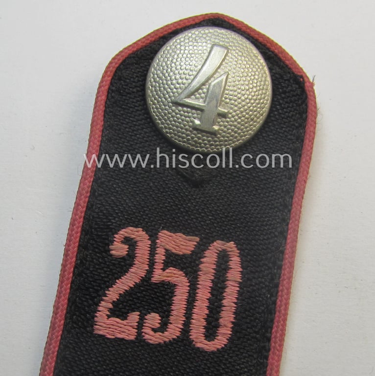 Single - and moderately worn - bright-pink-piped, so-called: 'Motor-HJ'-shoulderstrap as intended for a: 'Hitlejunge' who served within the 'Bann 250' (Bann 250 = 'Bann Goslar' situated in the 'Gebiet Nord Niedersachsen')