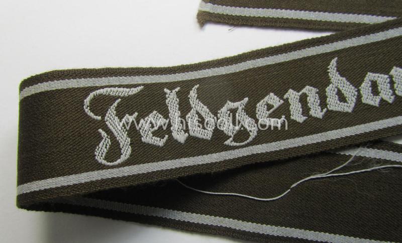 Superb - and scarcely encountered! - example of a WH (Heeres) cuff-title ie. armband (ie. 'Ärmelstreifen') entitled: 'Feldgendarmerie' (being a typical 'semi-BeVo'-woven!) example that comes in a full length- ie. non-shortened, condition