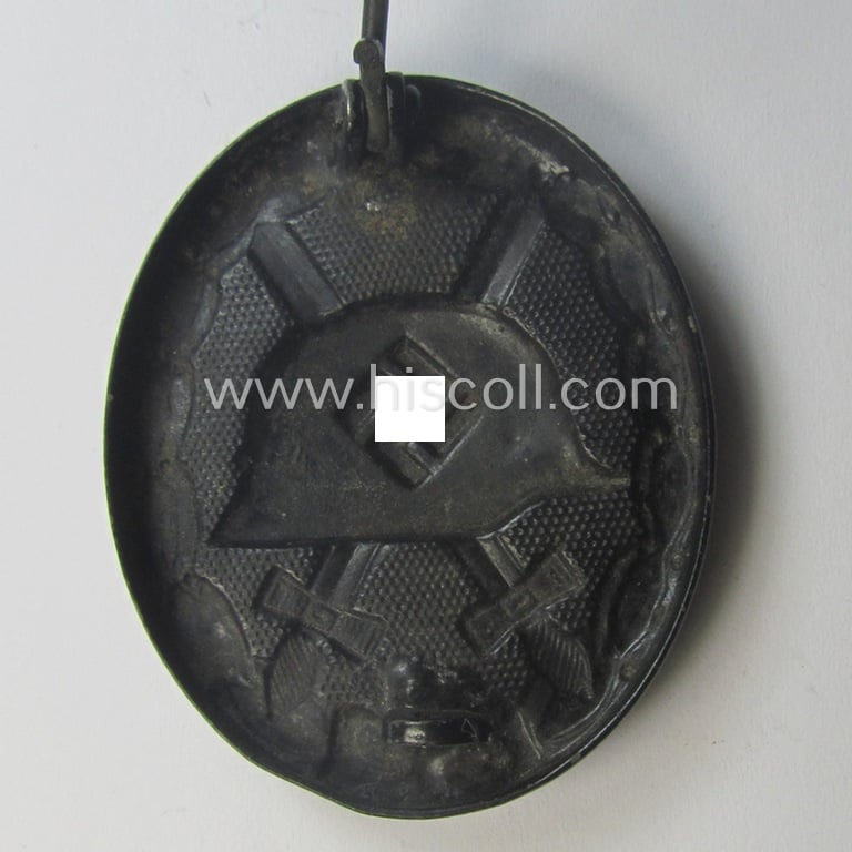 Black-class wound-badge (or: 'Verwundeten-Abzeichen in Schwarz') being a maker- (ie. '4'-) marked specimen as was produced by the maker (ie. 'Hersteller') named: 'Steinhauer & Lück'