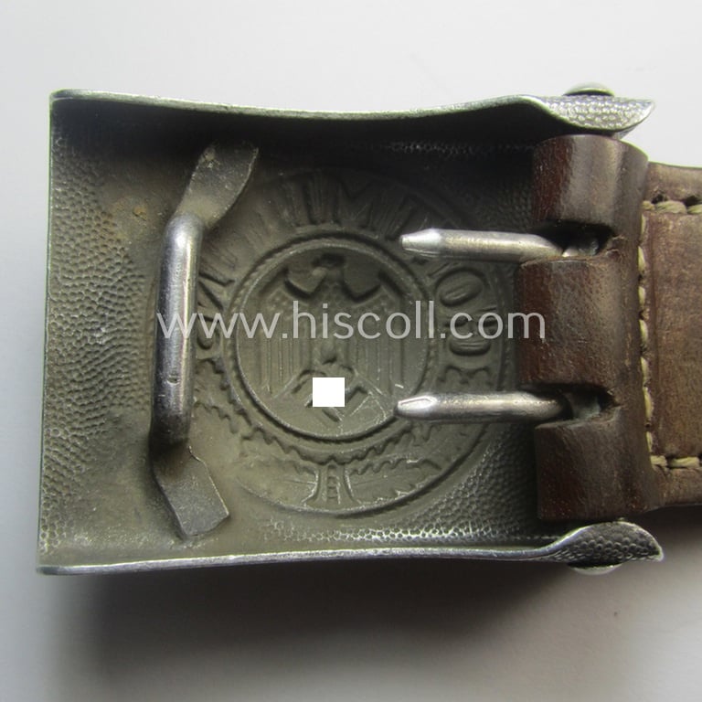 Moderately used WH (Heeres) 'standard-pattern', silver-toned- and aluminium-based belt-buckle being a maker- (ie. 'St.Merkl - Nürnberg'-) marked- and/or: '1938'-dated example that comes mounted onto its leather-based tab