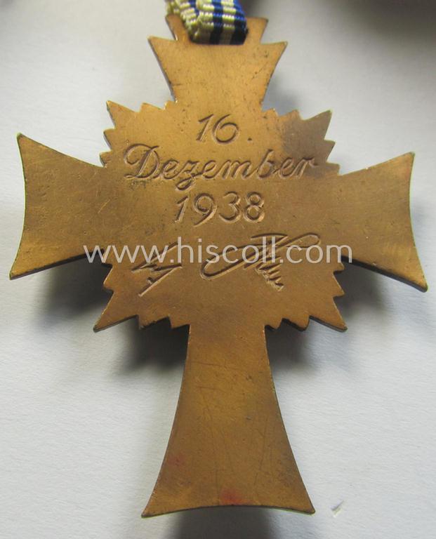 Neat, 'Ehrenkreuz der deutschen Mutter - dritte Stufe' being a non-maker-marked example that comes mounted onto its (large-sized!) ribbon and that comes in an overall very nice- (albeit minimally worn- ie. used-), condition