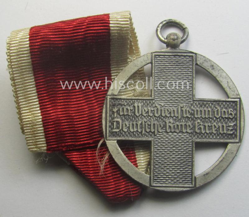 Superb, 'DRK-Ehrenzeichen des 3. Modell' that comes together with its original (regular-sized- and once-mounted) ribbon (ie. 'Bandabschnitt') as issued and/or stored for decades