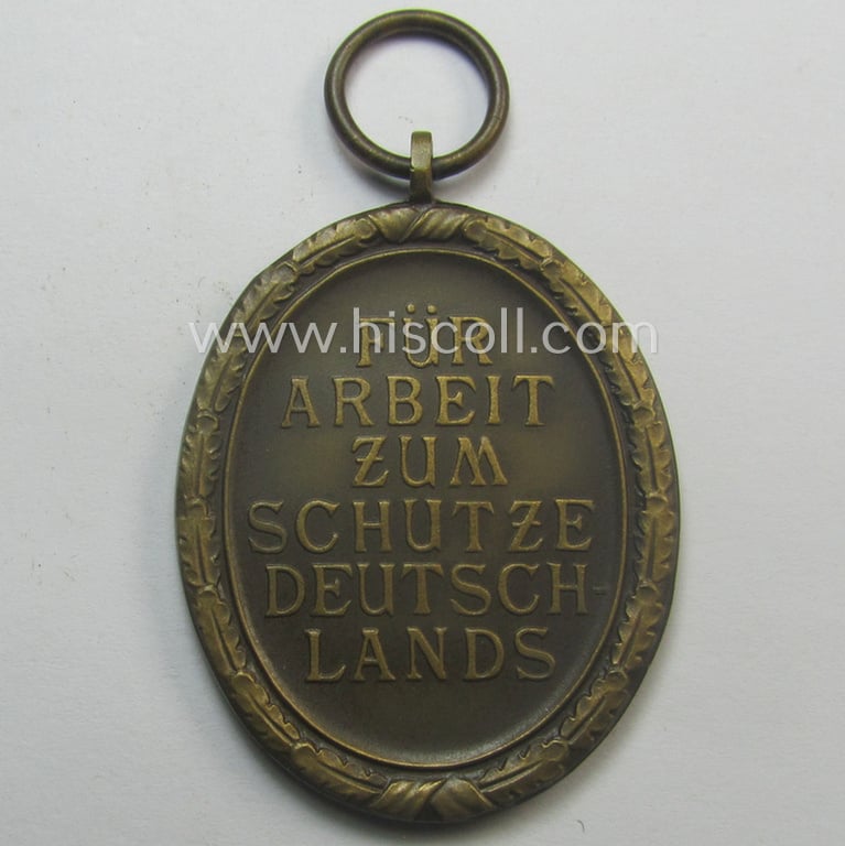Medal-set: 'Deutsches Schutzwall Ehrenzeichen' (aka: 'Westwall'-medal) being a (typical) non-maker-marked- and/or: typical 'Buntmetall'-based specimen that comes packed in its original pouch of issue by the: 'Wilh. Hobacher'-company