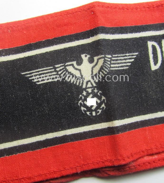 Typically printed- and/or later-war-period, bright-red- and/or black-coloured so-called: 'Deutscher Volkssturm'-armband (ie. 'Armbinde') that comes in an overall very nice- (I deem hardly used- nor worn- ie. 'virtually mint'-), condition