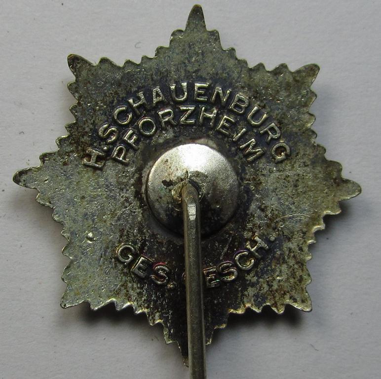 Semi-enamelled RLB- (ie. 'Reichluftschützbund') 'Zivilabzeichen' or: civil-attire badge (of the first pattern) that is neatly maker- (ie. 'H.Schauenburg - Pforzheim'-) marked and bearing a patent-pending- (ie. 'Ges.Gesch.'-) marking on its ba...