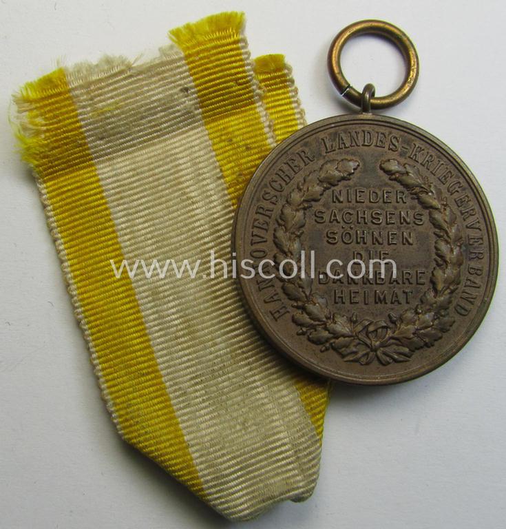 Attractive, (post)WWI-period - and neatly golden-bronze-toned! - so-called: 'Kriegsdenkmünze des Hannoverschen Landes-Kriegerverbandes' being a nicely preserved example that comes mounted onto its period ribbon (ie. 'Bandabschnitt')