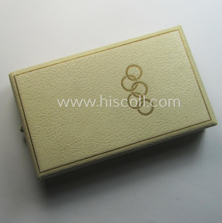 'Deutsche Olympia-Erinnerungsmedaille 1936' being a non-maker-marked example that comes mounted onto its original ribbon (ie. 'Bandabschnitt') and that comes stored in its typical, beige-white-coloured etui