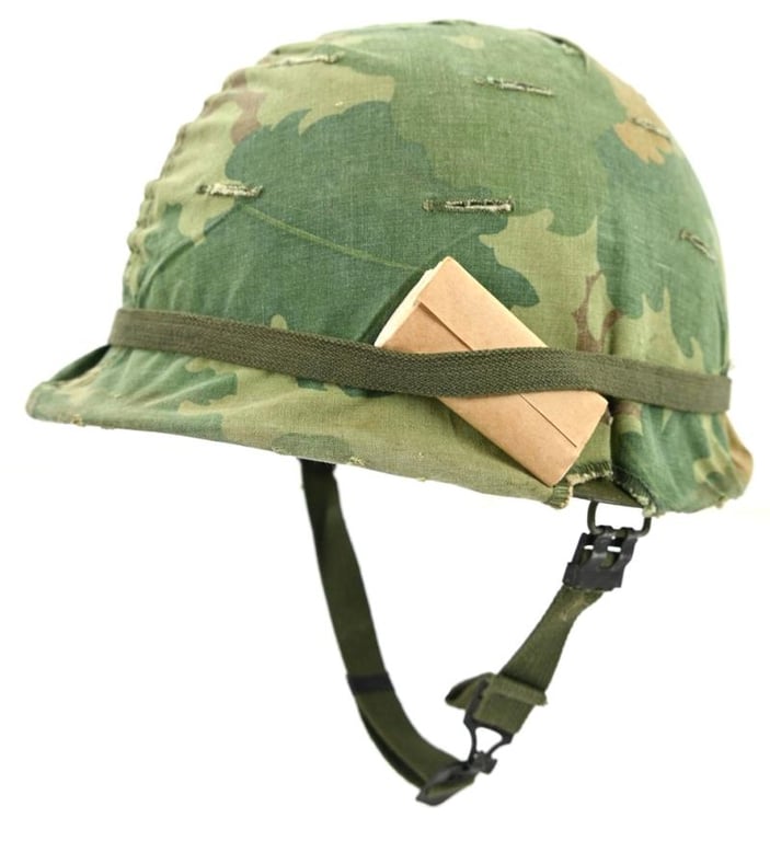 US Vietnam War Infantry helmet with camouflage cover and attached content