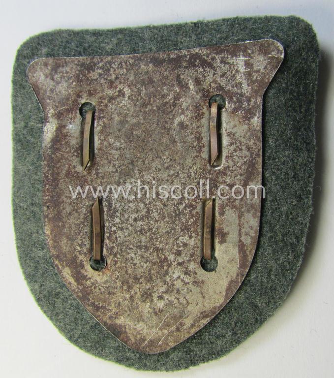 Attractive, WH (Heeres o. Waffen-SS) 'Krim'-campaign-shield that comes mounted onto its original, field-grey-coloured 'backing' and that comes in an issued-, minimally worn and/or (I deem) carefully tunic-removed-, condition