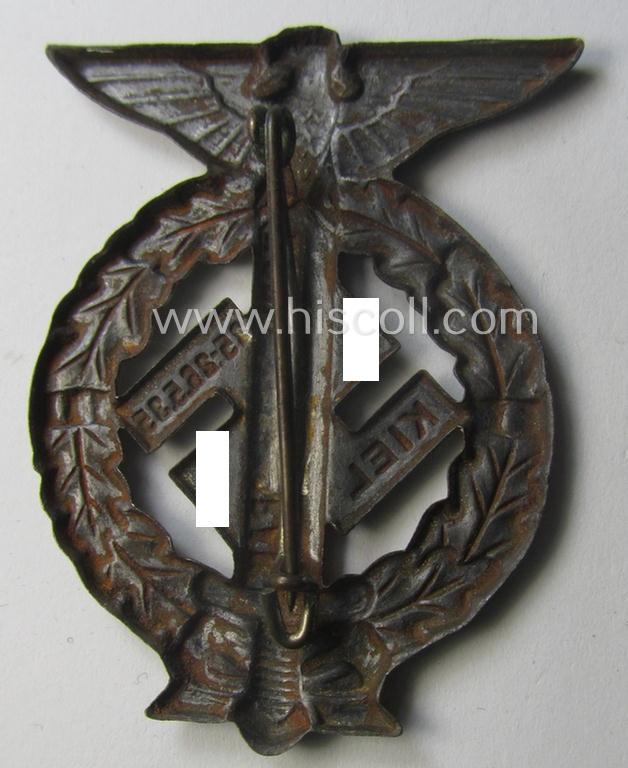 Commemorative, tarnished-silver-coloured- and/or tin-based, N.S.D.A.P.- (ie. SA-) related 'tinnie' being a non-maker-marked example depicting an upward-positioned sword, swastika and text that reads: 'Nordmark Voran - Kiel - 25.26.5.1935'