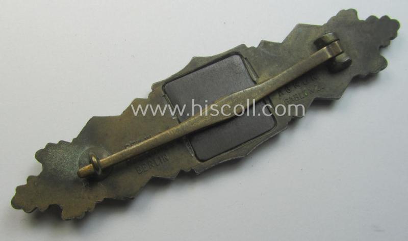 'Nahkampfspange in Bronze' (or: bronze-class close-combat clasp ie. CCC) being a maker- (ie. 'A.G.M.u.K.'-) marked- and/or minimal converse-shaped specimen having its period-attached (steel-based) 'back-plate' in place