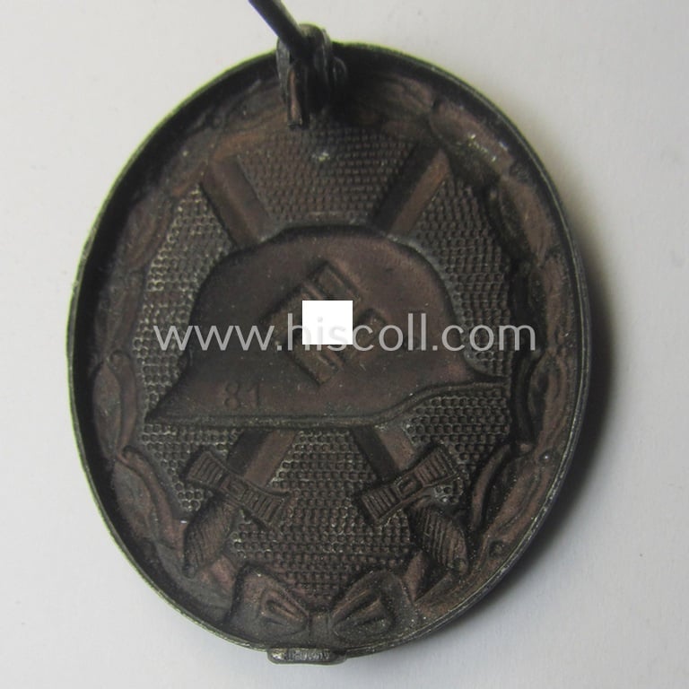 Neatly maker- (ie. '81'-) marked example of a black-class wound-badge (or: 'Verwundeten-Abzeichen in Schwarz') being an example that was produced by the maker (ie. 'Hersteller') named: 'Overhoff & Cie.'