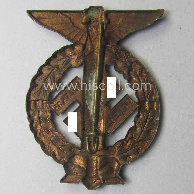 Commemorative, reddish-copper-coloured- and/or tin-based, N.S.D.A.P.- (ie. SA-) related 'tinnie' being a non-maker-marked example depicting an upward-positioned sword, swastika and text that reads: 'Nordmark Voran - Kiel - 25.26.5.1935'