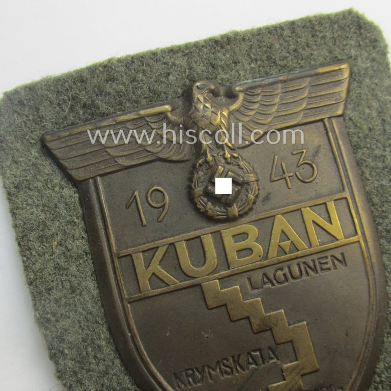 Stunning - and actually scarcely encountered! - WH (Heeres ie. Waffen-SS) 'Kuban'-campaign-shield (as was I deem produced by the maker: 'Karl Würster') and that comes mounted onto its original field-grey-coloured- and/or woolen-based 'backing'