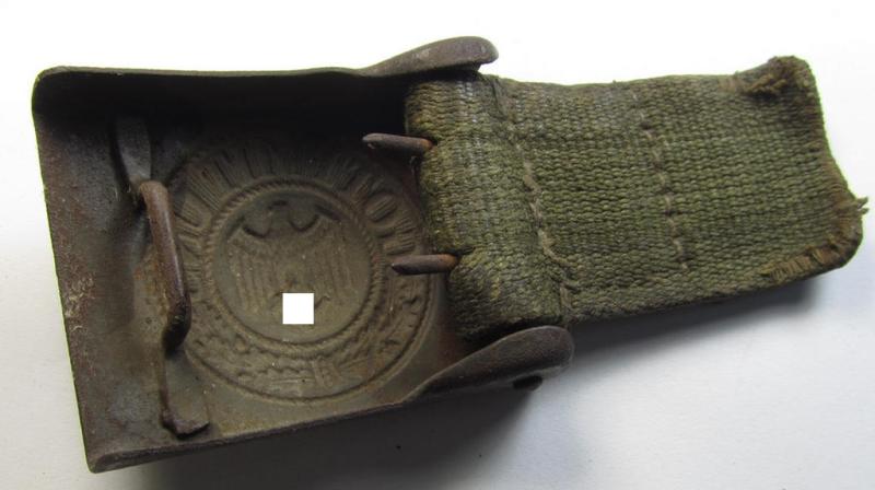 Neat, WH (Heeres) 'tropical-issued' belt-buckle (being a non-maker-marked and/or typical olive-green-coloured) example that comes mounted onto its original, greenish-coloured (and/or: 'webbing'-based-) tab