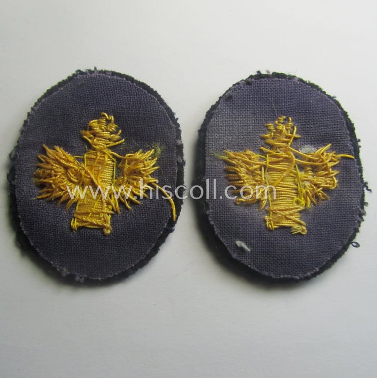 Fully matching set ie. pair of WH (Kriegsmarine) hand-embroidered career- ie. specialist-armbadges, as executed on dark-blue-coloured wool as intended for usage by an officer serving within a: 'Küstenartillerie'-unit