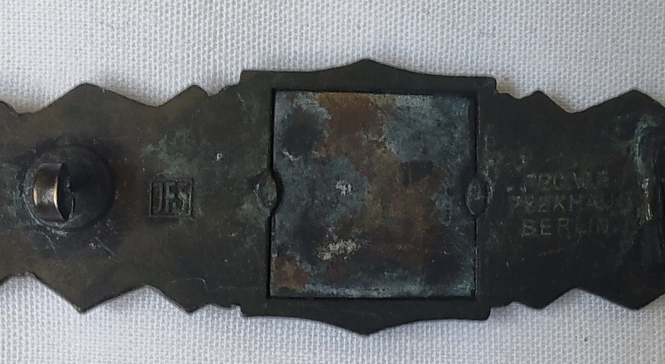 Reproduction 'Nahkampfspange in Bronze' (bronze class close combat clasp ie. CCC) being maker marked (ie 'JFS')