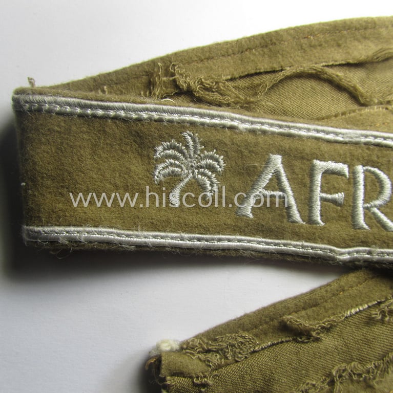 WH (LW o. Heeres) cuff-title (ie. 'Ärmelstreifen') entitled: 'Afrika' (being an example that comes in a presumably issued- albeit simply never used- ie. 'virtually mint' condition)