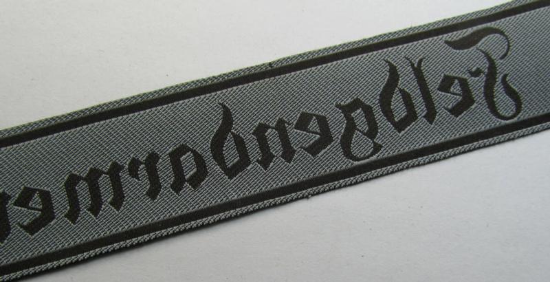 Superb - and scarcely encountered! - example of a WH (Heeres) cuff-title ie. armband (ie. 'Ärmelstreifen') entitled: 'Feldgendarmerie' (being a typical 'semi-BeVo'-woven!) example that comes in a minimally shortened, condition
