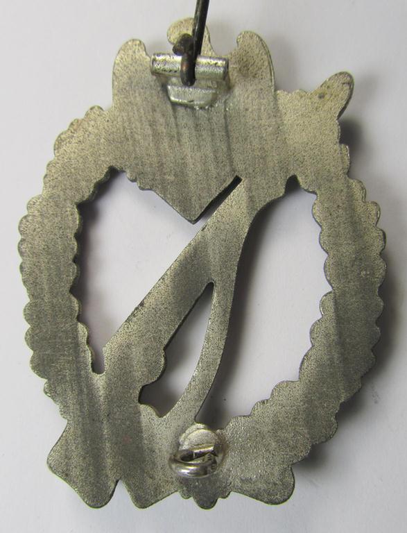 'Infanterie-Sturmabzeichen in Silber' being a non-maker-marked- and/or zinc- (ie. 'Feinzink'-) based specimen of the so-called: 'egg-head'-pattern (as was presumably produced by the 'Hersteller' ie. maker: 'Gustav Brehmer')